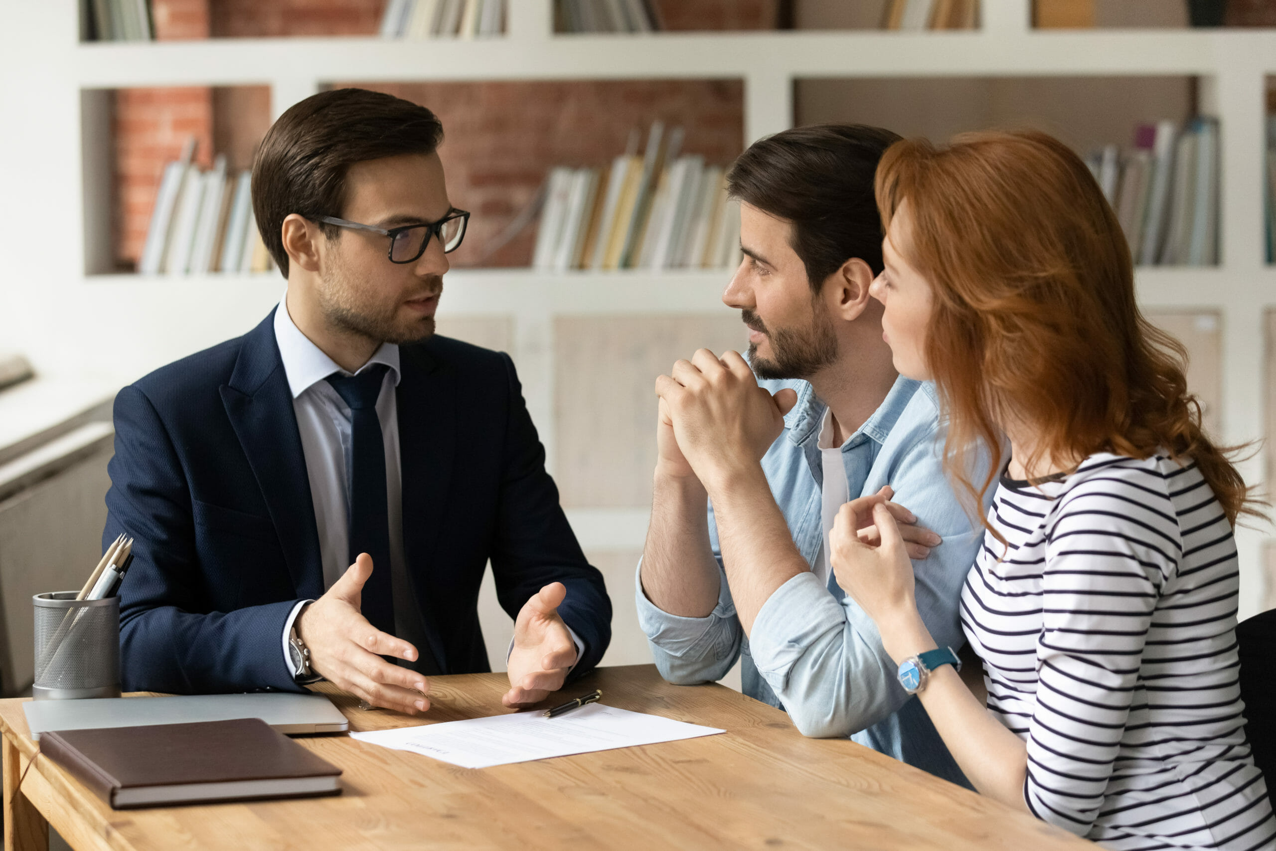 lawyer discussing with a couple shutterstock_2016949892-scaled