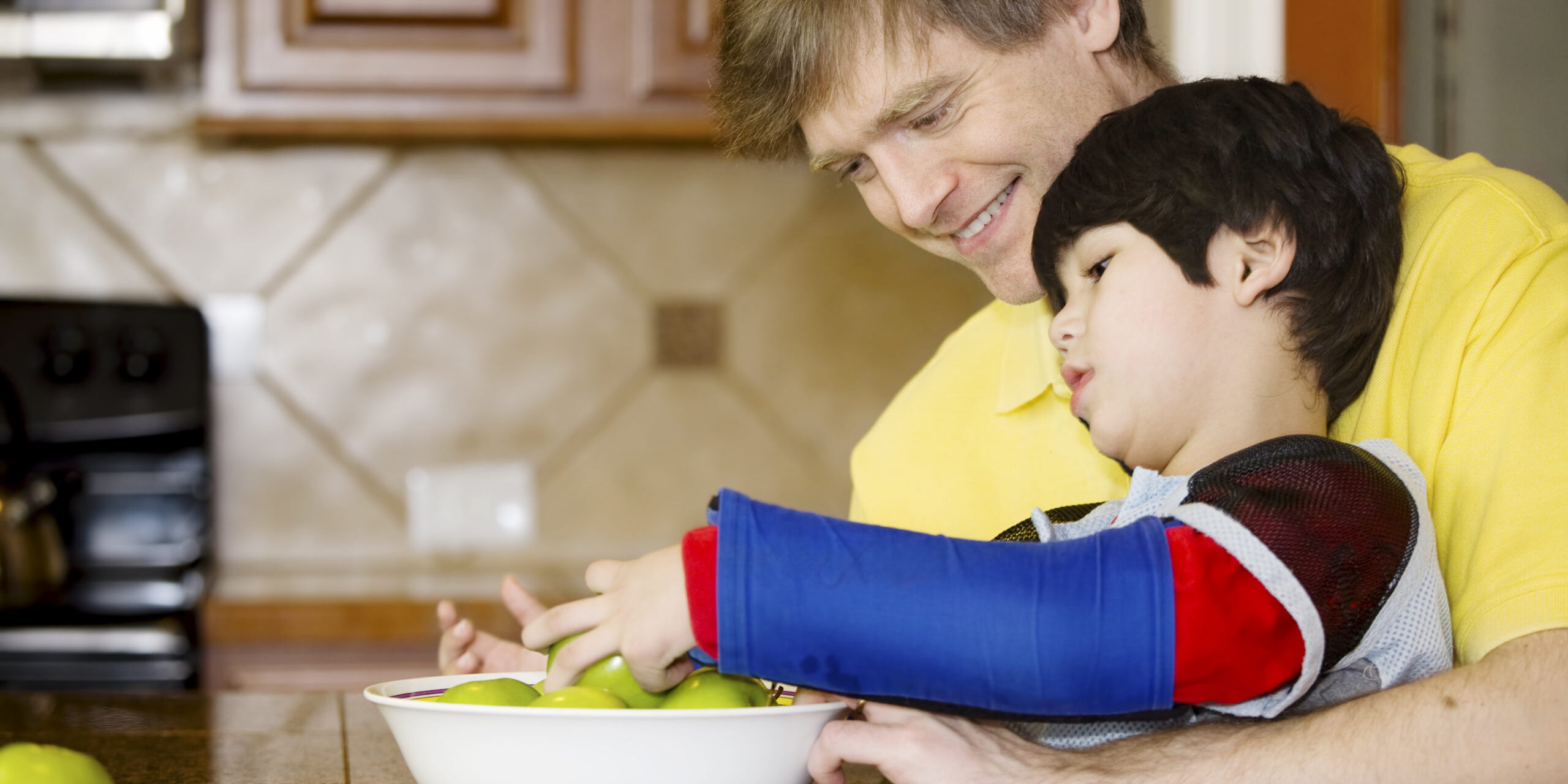 father and son with fruit bowl